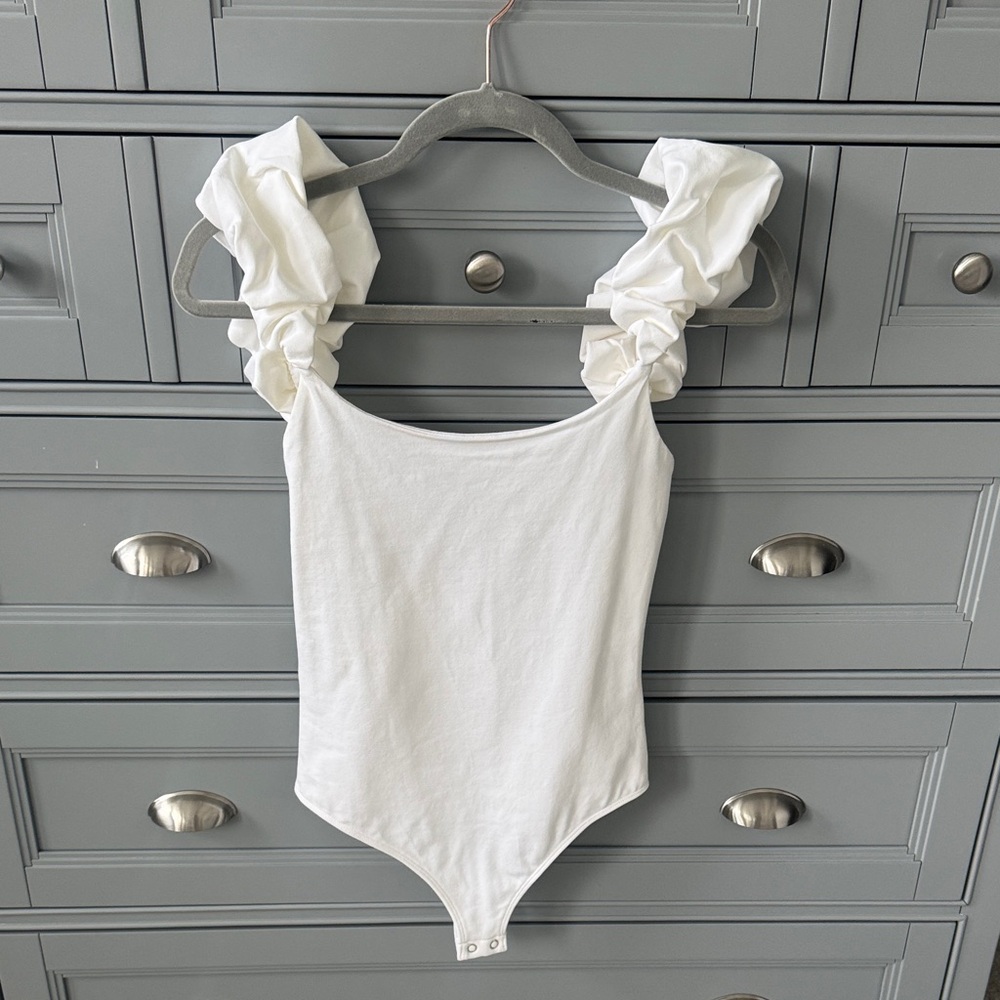Express White Ruffled-Shoulder One-Piece Bodysuit. Brand new never worn.